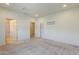 A carpeted bedroom with multiple doorways, recessed lights, and a skylight at 27413 W Tonopah Dr, Buckeye, AZ 85396