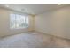 A carpeted bedroom is brightly lit by a large window with views of the outdoors at 27413 W Tonopah Dr, Buckeye, AZ 85396