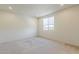 Cozy carpeted bedroom with a large window and recessed lights at 27413 W Tonopah Dr, Buckeye, AZ 85396