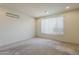 Well-lit carpeted bedroom featuring a large window and recessed lighting fixtures at 27413 W Tonopah Dr, Buckeye, AZ 85396