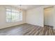 Bright dining room featuring wood-look floors, pendant lighting, and large windows at 27413 W Tonopah Dr, Buckeye, AZ 85396