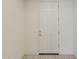 Interior view of a white front door with chrome hardware and tiled flooring at 27413 W Tonopah Dr, Buckeye, AZ 85396