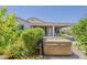 Backyard showcasing a relaxing hot tub and covered patio area with desert landscaping and easy access to the house at 27413 W Tonopah Dr, Buckeye, AZ 85396