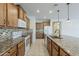 Kitchen is updated with granite counters, a tiled backsplash, and modern appliances at 27413 W Tonopah Dr, Buckeye, AZ 85396