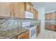 Kitchen features granite countertops, mosaic tile backsplash, and updated appliances at 27413 W Tonopah Dr, Buckeye, AZ 85396