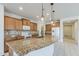 Kitchen includes granite counters, stainless appliances, and ample storage at 27413 W Tonopah Dr, Buckeye, AZ 85396