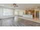 Spacious living area with open floor plan, wood floors, and a view into the kitchen at 27413 W Tonopah Dr, Buckeye, AZ 85396