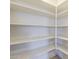 This walk-in pantry offers ample storage space with its numerous white shelves at 27413 W Tonopah Dr, Buckeye, AZ 85396