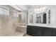Bright primary bathroom with a glass walk-in shower, dual sinks, and a large mirror at 31653 N 24Th Dr, Phoenix, AZ 85085