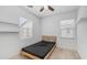 A bedroom with neutral carpet, two windows, a ceiling fan, and a bed at 31653 N 24Th Dr, Phoenix, AZ 85085