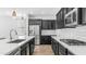 Modern kitchen featuring stainless steel appliances, white counters, tiled backsplash, and stylish pendant lights at 31653 N 24Th Dr, Phoenix, AZ 85085