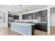 Beautiful kitchen with stainless steel appliances, white quartz counters and island with blue decorative accents at 31653 N 24Th Dr, Phoenix, AZ 85085
