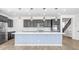 Stylish kitchen featuring stainless steel appliances, large island, pendant lighting, and dark cabinetry at 31653 N 24Th Dr, Phoenix, AZ 85085
