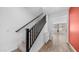 Carpeted staircase with black banister leading to the upper level of the home at 31653 N 24Th Dr, Phoenix, AZ 85085
