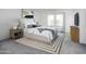 Bright bedroom featuring a comfortable bed, soft lighting, and minimalist decor, offering a peaceful retreat at 32218 N Knauss Ln, San Tan Valley, AZ 85143