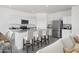 Modern kitchen with stainless steel appliances, granite counters, and a breakfast bar at 32218 N Knauss Ln, San Tan Valley, AZ 85143