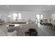 Spacious living and dining area with modern furnishings and ample natural light, creating an inviting atmosphere at 32218 N Knauss Ln, San Tan Valley, AZ 85143