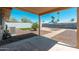 Open backyard featuring rockscape, palm trees, privacy wall, and a covered patio at 3231 W Banff Ln, Phoenix, AZ 85053