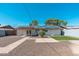 Rear of the house with desert rockscape, brick patio, solar panels, and a lawn area at 3231 W Banff Ln, Phoenix, AZ 85053