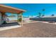 Open backyard featuring rockscape, palm trees, privacy wall, and a built-in firepit at 3231 W Banff Ln, Phoenix, AZ 85053