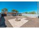 Private backyard with a cozy fire pit and low-maintenance desert landscaping at 3231 W Banff Ln, Phoenix, AZ 85053