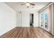Bedroom with vinyl flooring, closet, and double doors to the outside at 3231 W Banff Ln, Phoenix, AZ 85053