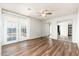 Bedroom with wood floors, mirrored closet, ceiling fan, and access to the backyard at 3231 W Banff Ln, Phoenix, AZ 85053