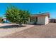 Front exterior of house with mature tree, desert landscaping, and solar panels at 3231 W Banff Ln, Phoenix, AZ 85053