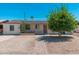 Charming single-story home featuring solar panels, desert landscaping, and a brick walkway at 3231 W Banff Ln, Phoenix, AZ 85053