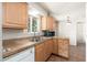 Well-lit kitchen with stainless steel sink and tile countertops at 3231 W Banff Ln, Phoenix, AZ 85053