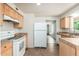Open kitchen featuring white appliances, ample cabinet space and neutral tile flooring at 3231 W Banff Ln, Phoenix, AZ 85053