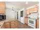 Functional kitchen with white appliances and convenient laundry closet at 3231 W Banff Ln, Phoenix, AZ 85053