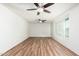 Bright living room with two ceiling fans, wood-look flooring, and a large window at 3231 W Banff Ln, Phoenix, AZ 85053