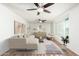 Stylishly staged living room with a plush sofa, elegant decor, and a large window at 3231 W Banff Ln, Phoenix, AZ 85053