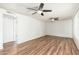 Spacious living room with two ceiling fans and wood-look flooring at 3231 W Banff Ln, Phoenix, AZ 85053