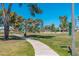 Playground at neighborhood park featuring slides, swings, and a walking path at 3231 W Banff Ln, Phoenix, AZ 85053
