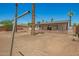The backyard features desert landscaping, palm trees, and a covered patio at 3302 N 40Th Dr, Phoenix, AZ 85019