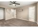 Cozy bedroom with carpet flooring, neutral walls, and a ceiling fan at 3302 N 40Th Dr, Phoenix, AZ 85019