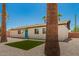 Inviting single-story home featuring a blue door, with manicured stone landscaping and tall palm trees at 3302 N 40Th Dr, Phoenix, AZ 85019