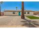 Charming single-story home with a well-maintained yard, stone landscaping, and a bright blue front door at 3302 N 40Th Dr, Phoenix, AZ 85019