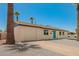 Inviting single-story home featuring a blue door, with manicured stone landscaping and tall palm trees at 3302 N 40Th Dr, Phoenix, AZ 85019