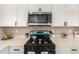 Close-up of a kitchen featuring new stainless steel microwave and modern gas range at 3302 N 40Th Dr, Phoenix, AZ 85019