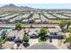 Expansive aerial view of a residential neighborhood showcasing well-manicured lawns and community amenities at 34970 N Spur Cir, San Tan Valley, AZ 85144