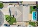 Aerial shot of a single-Gathering home with a unique roof design, a private pool, and well-kept landscaping at 34970 N Spur Cir, San Tan Valley, AZ 85144