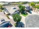 Aerial view of a single-Gathering home featuring mature trees, a well-manicured lawn, and a circular driveway at 34970 N Spur Cir, San Tan Valley, AZ 85144