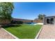 Lush backyard featuring green turf, a sparkling pool, and ample space for outdoor activities and entertainment at 34970 N Spur Cir, San Tan Valley, AZ 85144