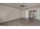 Spacious bedroom with tiled floors, neutral walls, and a ceiling fan with an open door at 34970 N Spur Cir, San Tan Valley, AZ 85144