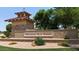 Welcome to Morning Sun Farms; a beautiful community with lush landscaping, decorative stone walls, and mature trees at 34970 N Spur Cir, San Tan Valley, AZ 85144