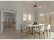 Elegant dining room with a modern table setting, wood-look floors, and an open transition to the living area at 34970 N Spur Cir, San Tan Valley, AZ 85144