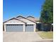 Charming single-story home with a three-car garage, neutral color palette, and well-manicured landscaping at 34970 N Spur Cir, San Tan Valley, AZ 85144